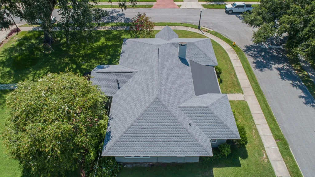 Aerial view of a completed Stronghold Roofing light-gray architectural shingle roof on a Florida home