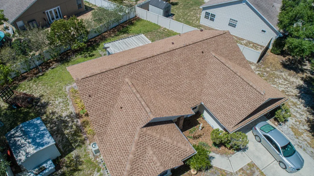 Aerial view of a completed Stronghold Roofing warm brown architectural shingle roof on a Florida home