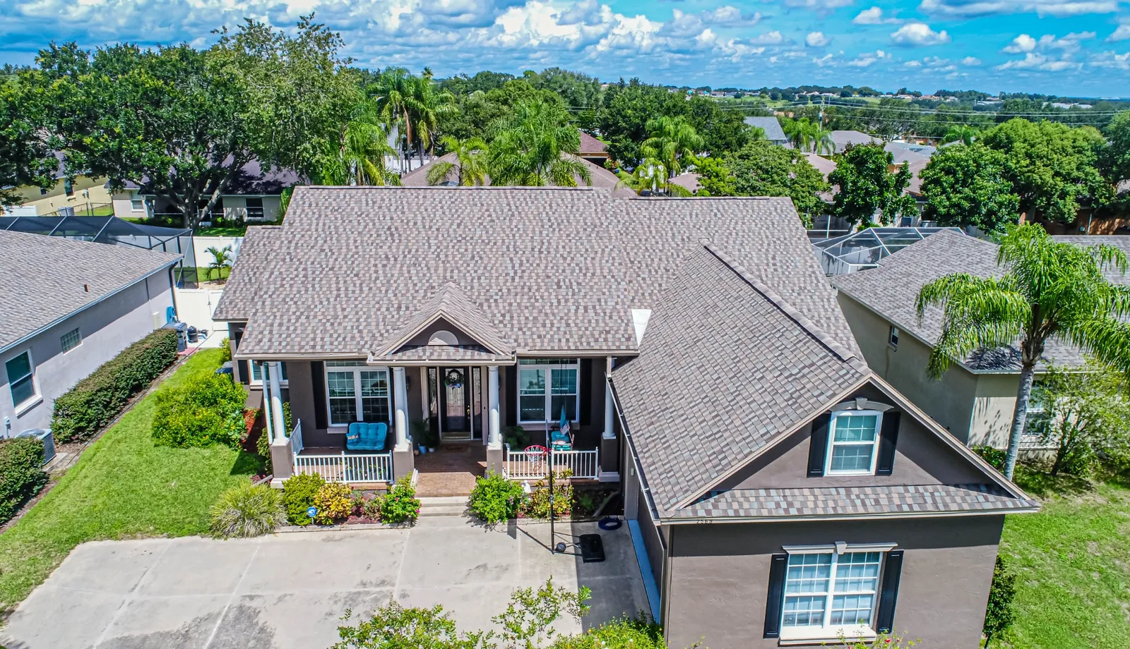 Aerial view of a Stronghold charcoal shingle roof on a Florida home with mature landscaping