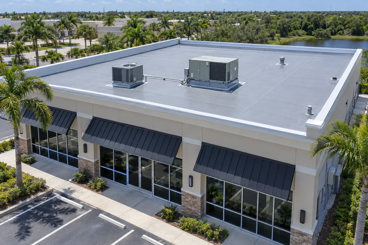 Aerial view of a Florida commercial storefront with a slightly sloped gray PVC flat roof