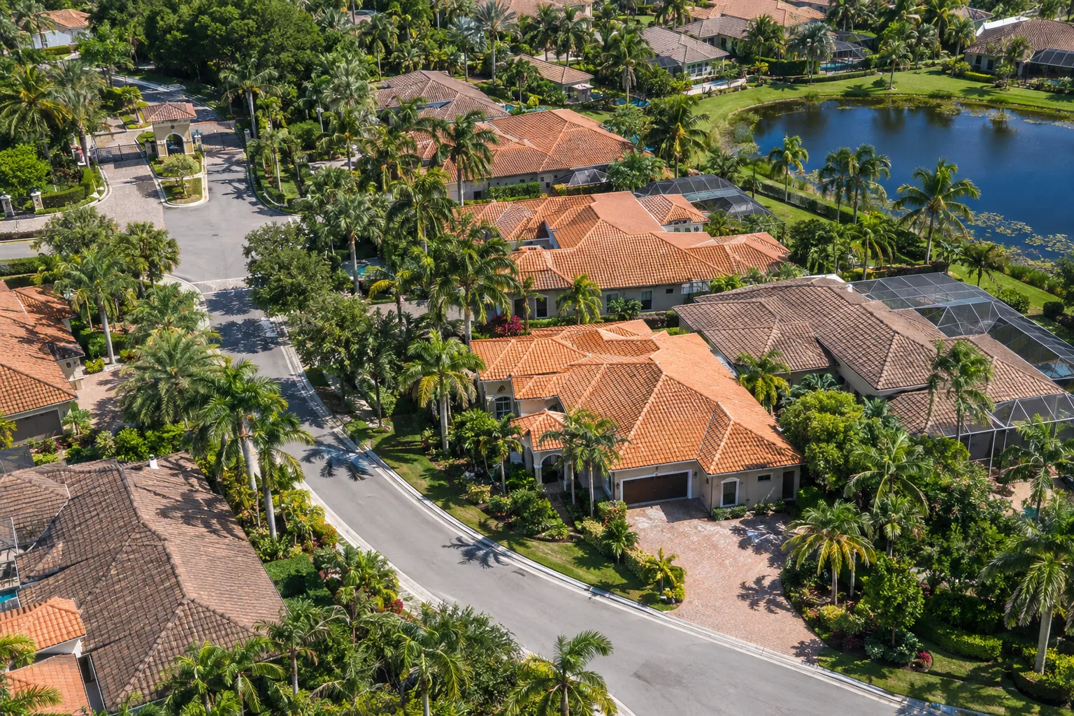 Aerial view of a Florida gated community with terracotta and brown clay tile roofs