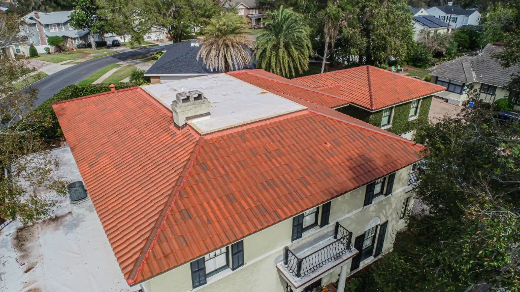 Aerial view of a completed Stronghold Roofing terracotta clay barrel tile roof on a Florida Mediterranean two-story home