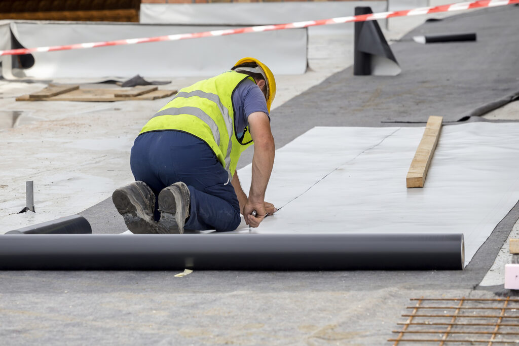 Waterproofing and insulation at construction site waterproofing membrane preventing water penetration. Exterior vapor barrier for foundations and basements.
