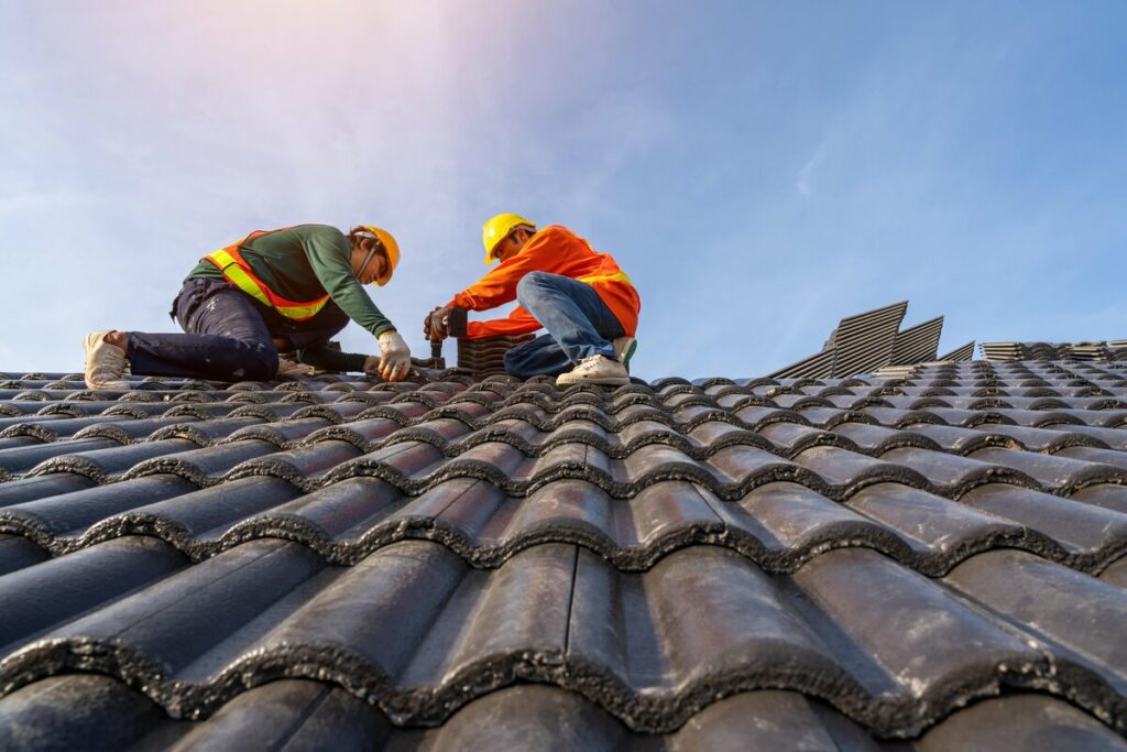 After an insurance claim is accepted, roofers repair the roof in Lakeland