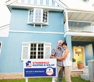 Joyful couple enjoying a worry-free roof thanks to reliable roofing services