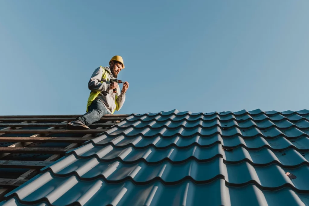A man is working on a metal roof in Lakeland