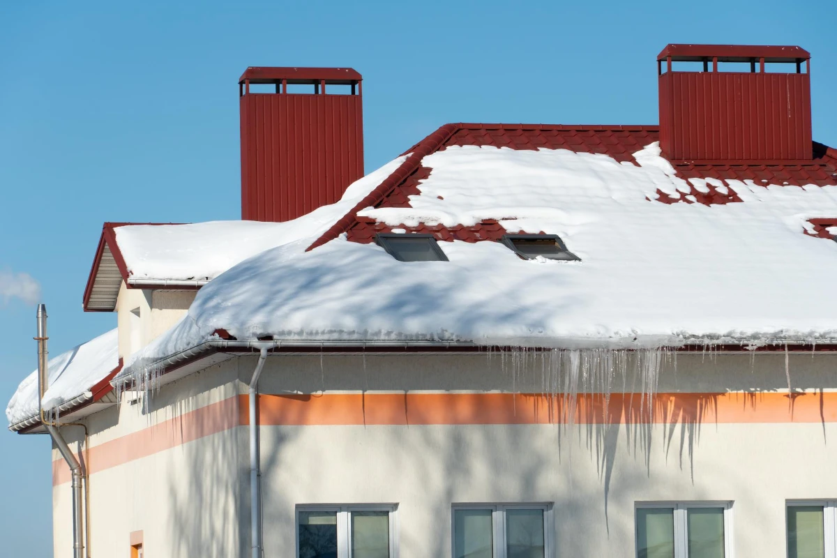 the roofs of the buildings are covered with snow and ice