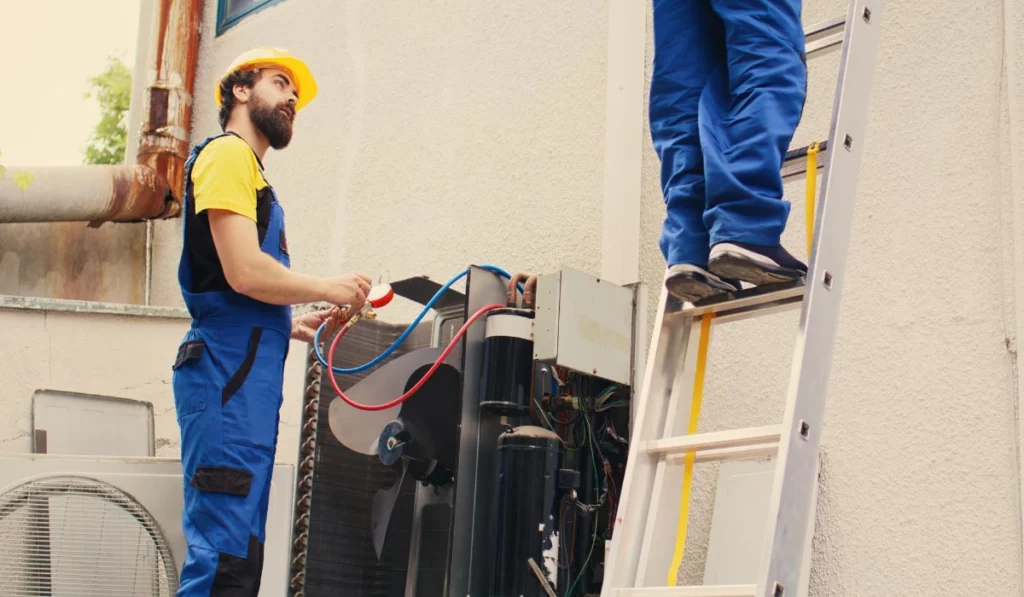 Expert and coworker servicing condenser in Lakeland