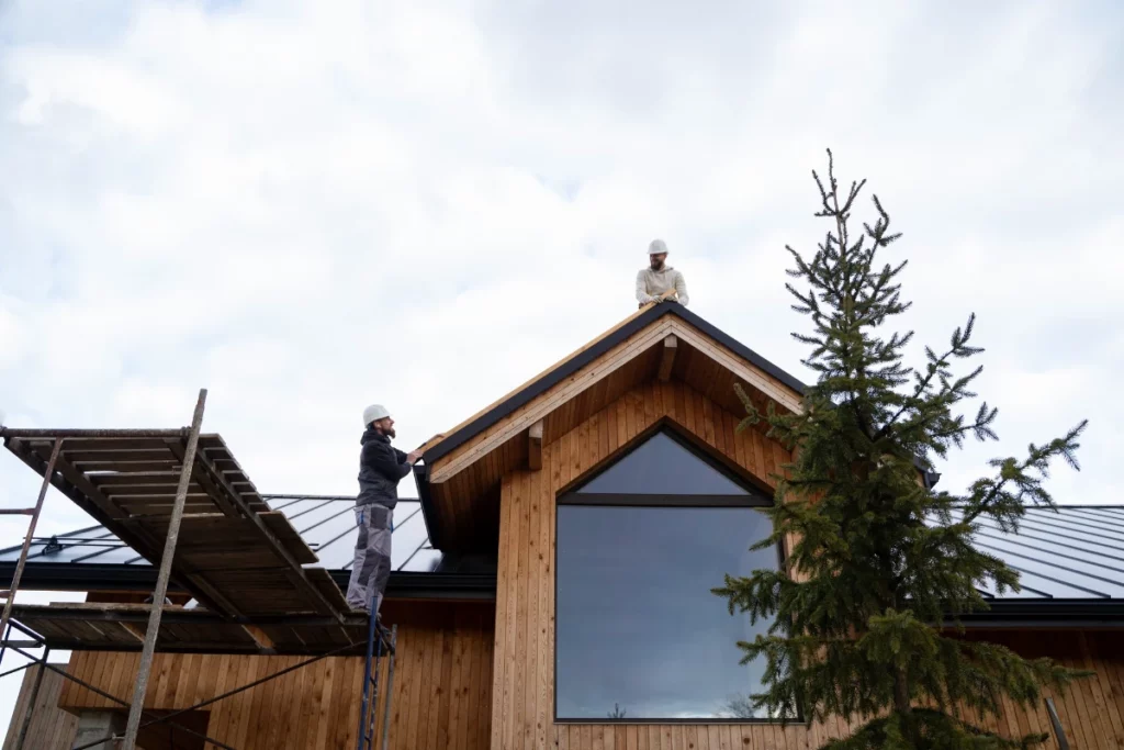 Long shot men working together on roof in Lakeland