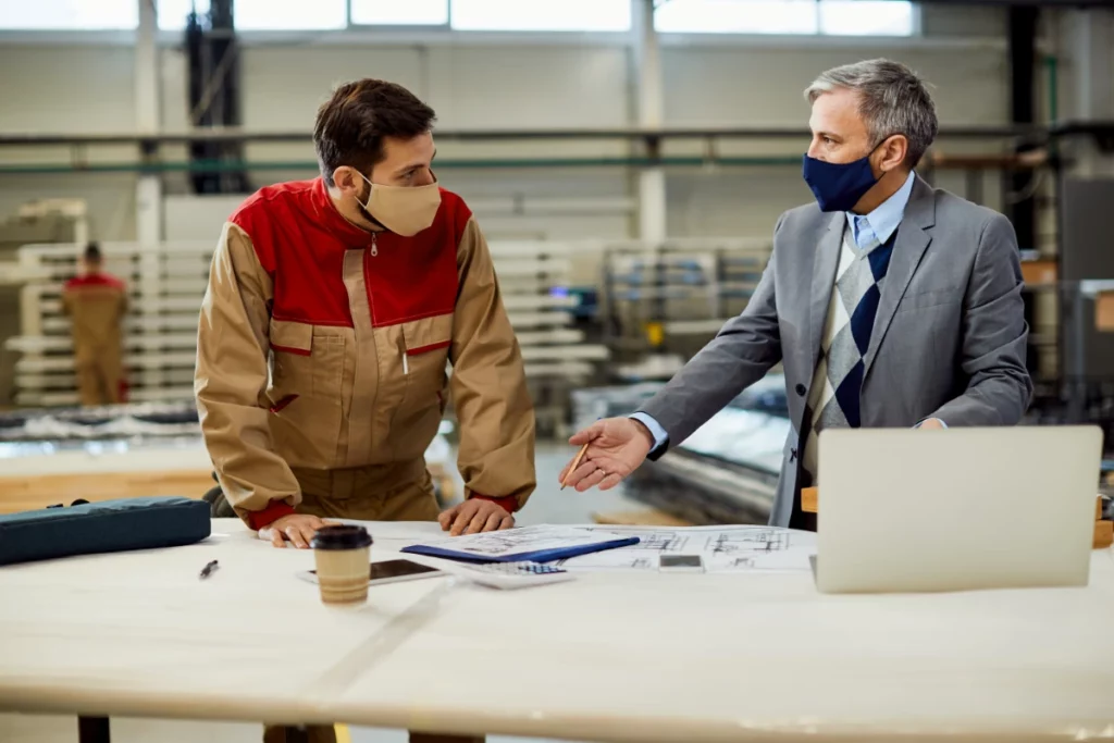 Project manager and carpenter discussing warranty agreement