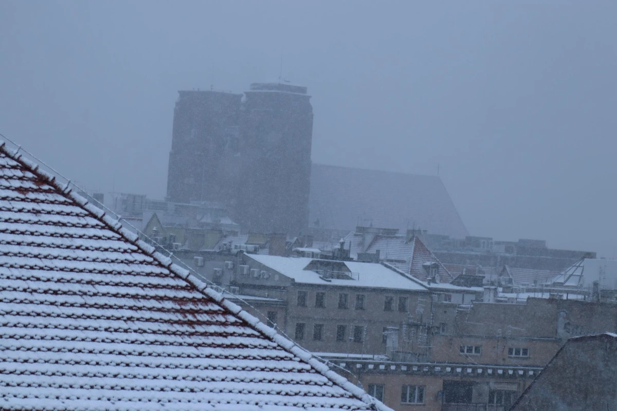 Buildings in city against sky during winter