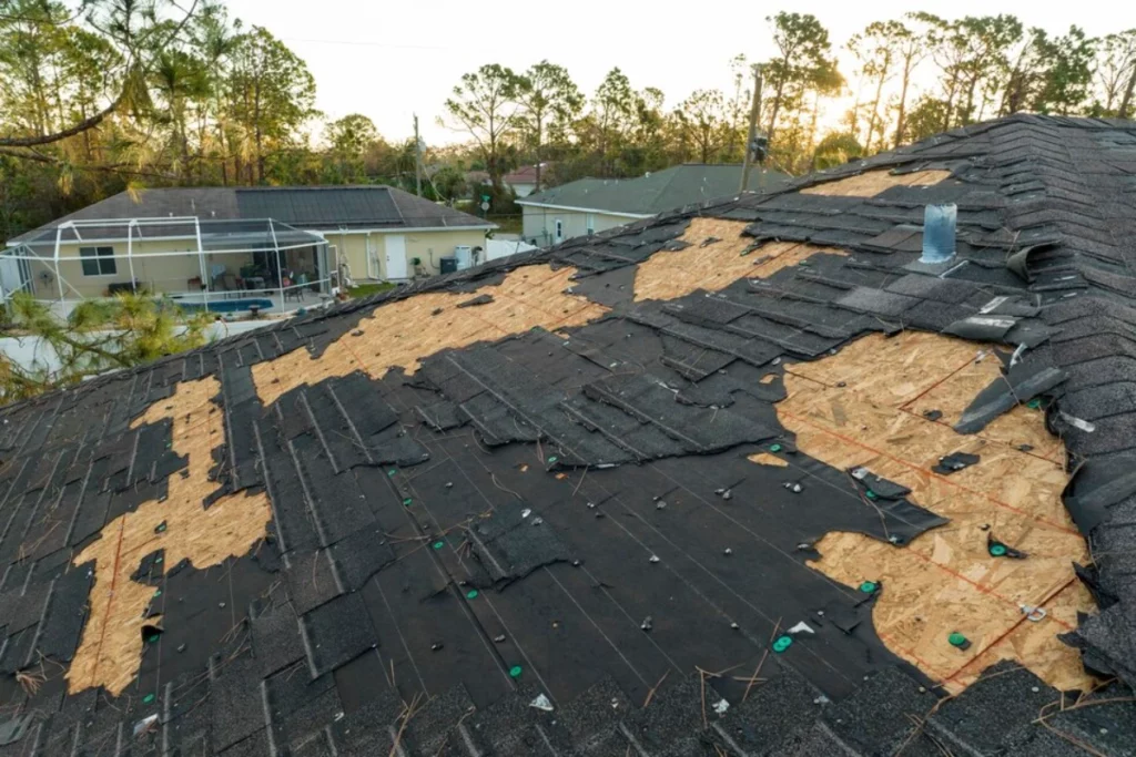ruined-rooftop-need-repair-wind-damaged-house-roof-with-missing-asphalt-shingles-after-hurricane-ian-florida-large