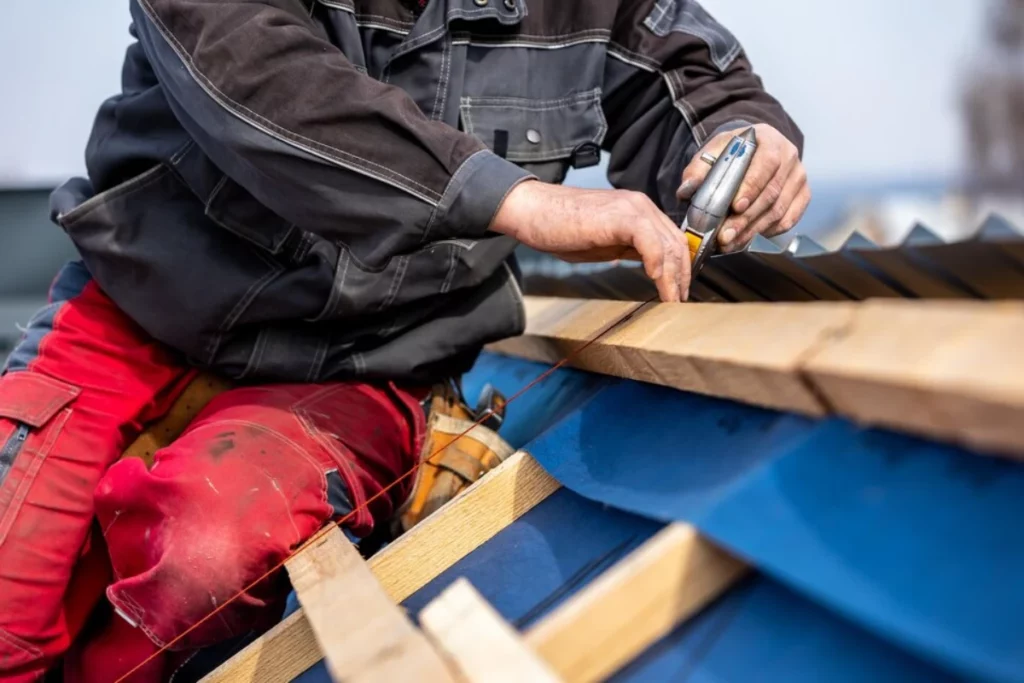 A man on a roof doing roof maintenance