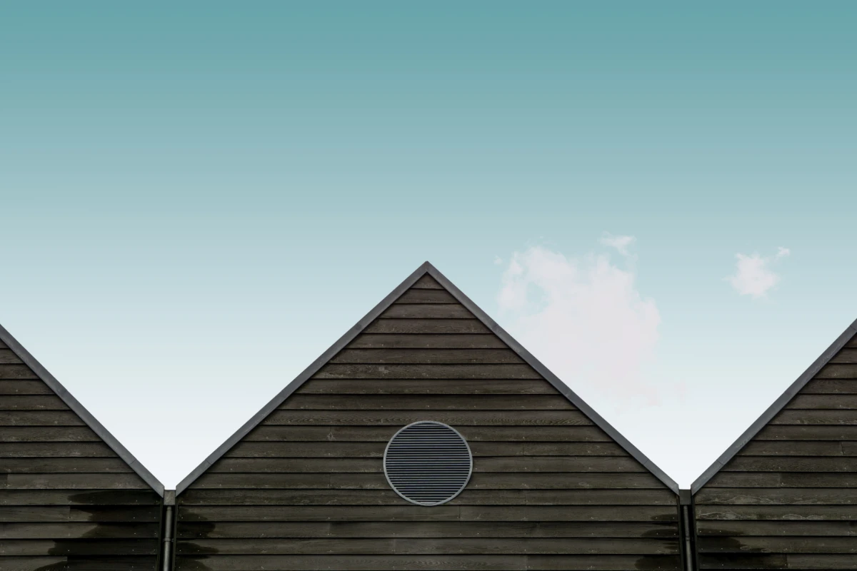 Low angle view of the wooden brown houses under the blue sky 